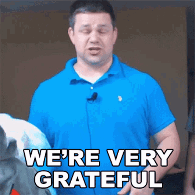 a man in a blue shirt says we 're very grateful with his eyes closed