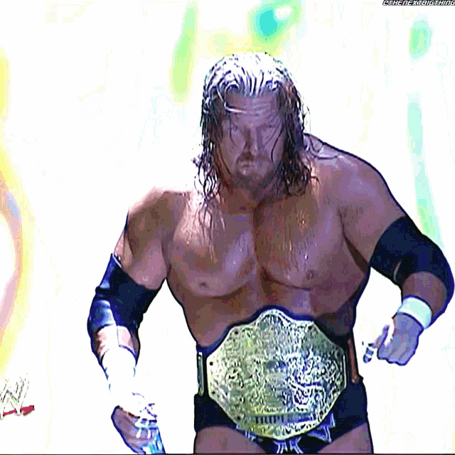 a wrestler is wearing a belt that says ' triple h ' on it