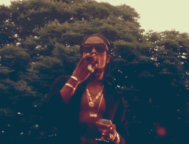 a man wearing sunglasses and a necklace that says 2010 on it
