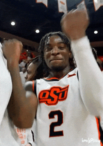 a basketball player with the number 2 on his jersey is cheering