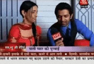 a man and a woman are being interviewed on tv