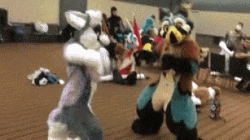 a group of people in furry costumes are dancing in a room