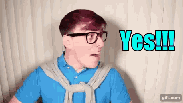 a man wearing glasses and a blue shirt says " yes "
