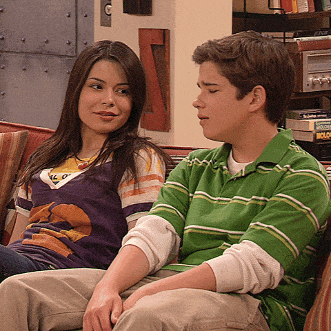 a boy in a green striped shirt sits next to a girl who is wearing a purple shirt