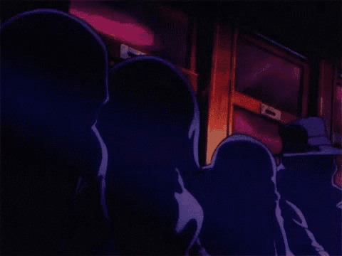 a group of skeletons are sitting next to each other in a room with purple lights .