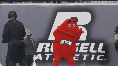 a mascot for nku stands in front of a russell athletic logo