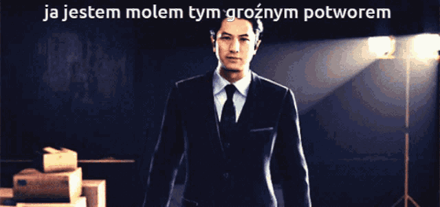 a man in a suit and tie stands in front of a sign that says " ja jestem molem tym groznym potworem "