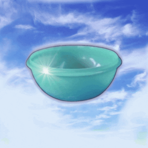 a green bowl is floating in the air with the sun shining on it