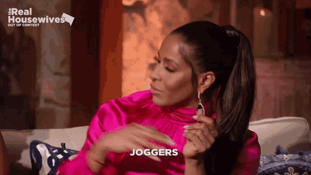 a woman sitting on a couch with the word joggers written on her face