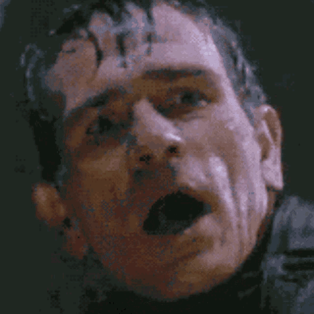 a close up of a man 's face with his mouth wide open .