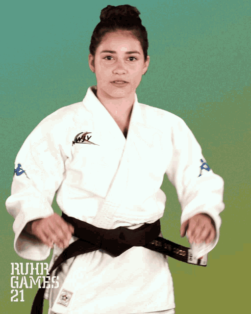 a woman in a karate uniform with ruhr games 21 on the bottom right