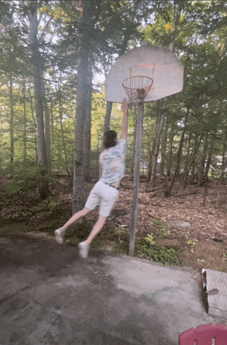 a man playing basketball in the woods with a t-shirt that says ' i love you ' on it