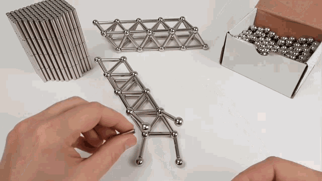 a person playing with a set of magnetic sticks and balls