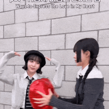 two girls are holding a red heart shaped balloon with the words " ways to express the love in my heart " on the bottom