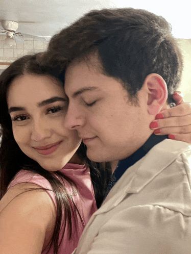 a man and a woman are posing for a picture together