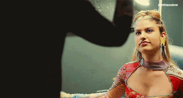 a woman in a red dress is looking at herself in a mirror with the hashtag #thisscene
