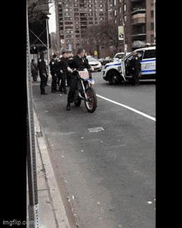 a police officer on a motorcycle with a license plate that says ' n.y.p.d. ' on it