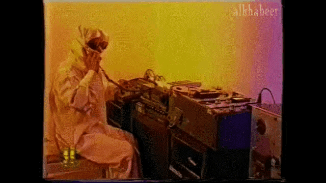 a video of a man talking on a phone with the word alphabet on the bottom left