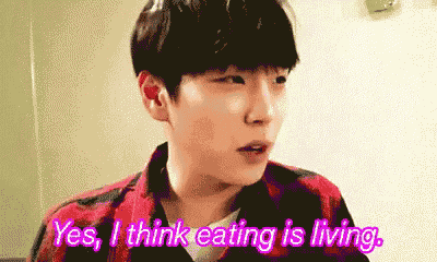 a young man in a plaid shirt says yes i think eating is living .