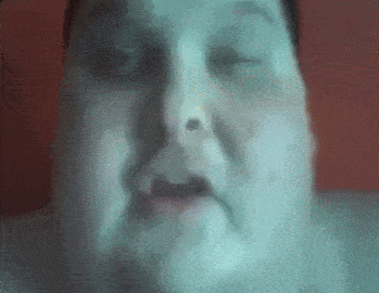 a close up of a man 's face with his eyes closed and his mouth open