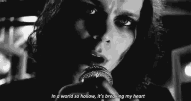 a man is singing into a microphone with a quote .
