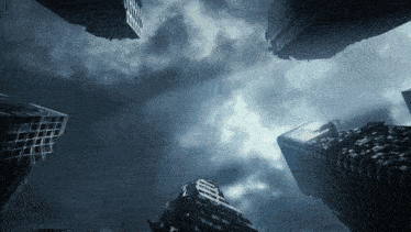 looking up at a city skyline with a dark cloudy sky