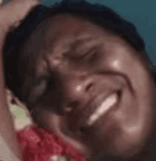a close up of a man eating a piece of watermelon .