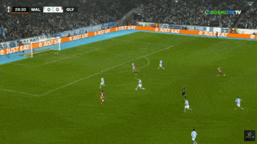 a soccer game is being played in front of a crowd with ads for cosmote tv
