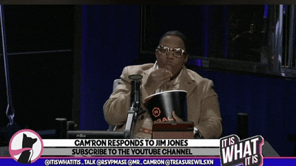 camron responds to jim jones while sitting at a table