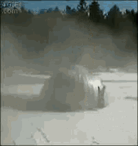 a car is driving through a snowy field with smoke coming out of it ..