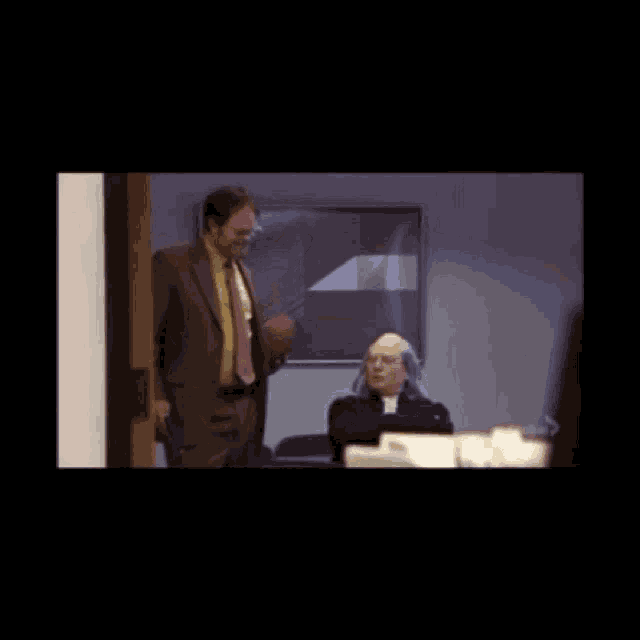 a man in a suit throws a football in the air