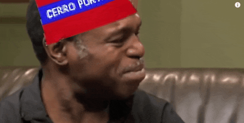 a man wearing a red and blue hat that says cerro puerto on it