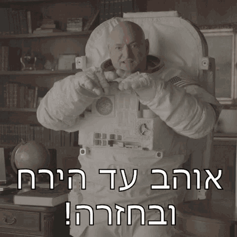 a bald man in a space suit is sitting in front of a desk