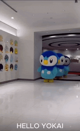 a group of stuffed penguins are standing in a hallway with the words hello yokai above them