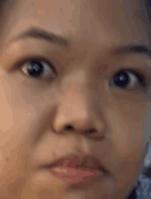 a close up of a woman 's face with a slight smile on her face .