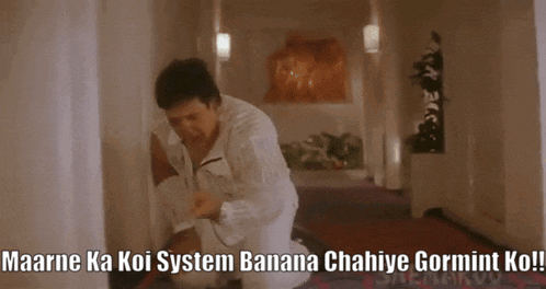 a man kneeling down in a hallway with the words maarne ka koi system banana chahiye gormint ko written on the bottom