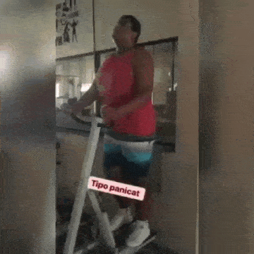 a man in a red tank top is standing on a treadmill with a sign that says tipo panicat on it