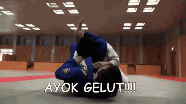 a judo match with the words ayok gelut written above it