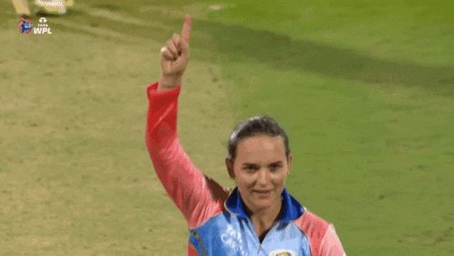 a woman wearing a blue and red jacket with the word captain on the front