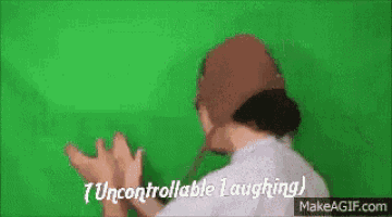 a person is laughing on a green screen while wearing a hat .