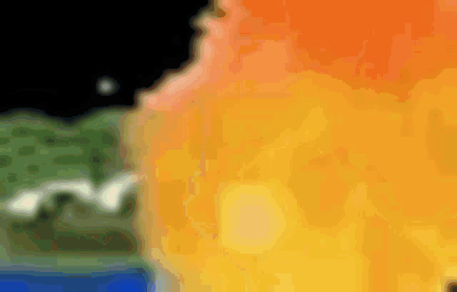a close up of a fire with a blurred background and a few trees in the background .