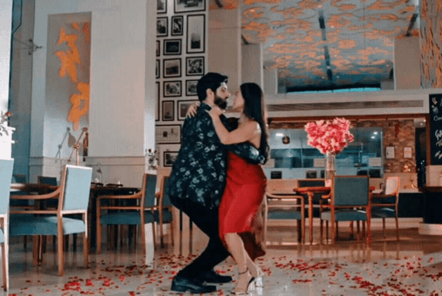 a man and woman are dancing together in a restaurant