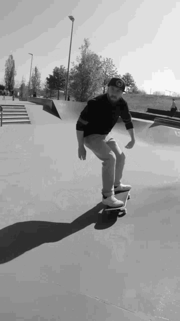 a man is riding a skateboard in a black and white photo with a hat that has the letter o on it