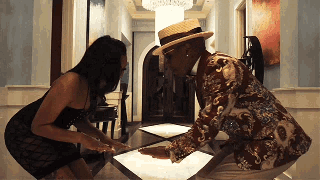 a man and a woman are standing next to each other in a hallway