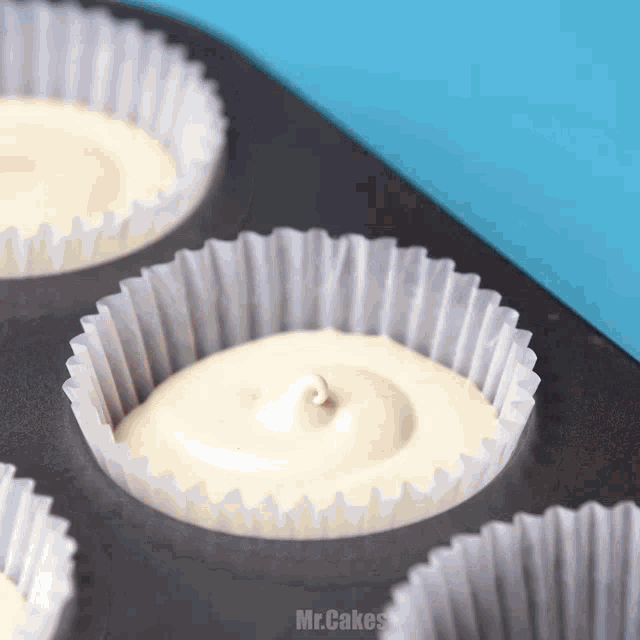 a muffin tin filled with cupcakes with mr.cakes written on the bottom right