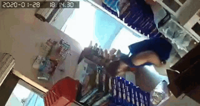 a woman is standing in a store looking down at a stack of diapers .