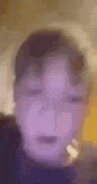 a blurry picture of a person 's face with a purple background