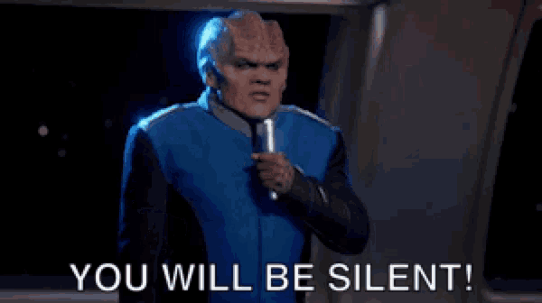 a man holding a microphone says you will be silent