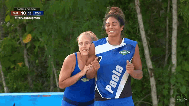 two female athletes wearing blue paola uniforms