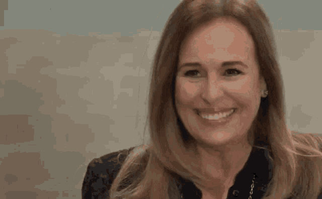 a close up of a woman smiling with her mouth open .